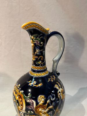 a blue and gold vase sitting on a white table