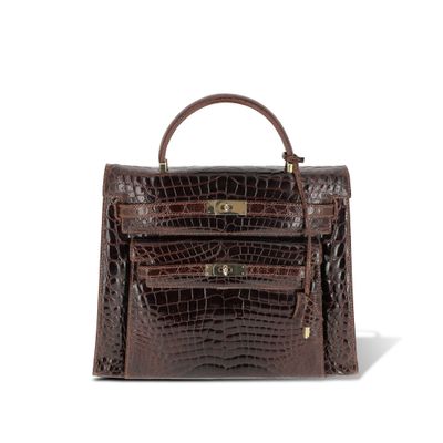 a brown crocodile skin handbag on a white background