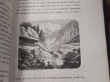 an open book with a picture of a mountain scene on it