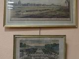 two framed pictures hanging on the wall of a room