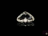 a close up of a clear diamond on a black surface