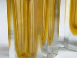 three yellow vases sitting next to each other on a table