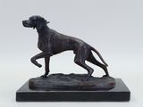 a bronze statue of a dog on a marble base
