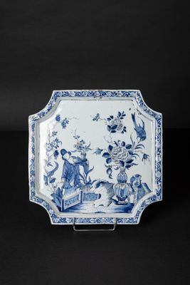 an antique blue and white plate with flowers and birds on it
