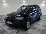 a picture of a black bmw suv parked in a garage