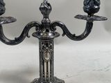 a silver candelab with three candles on it