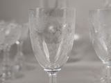 several empty wine glasses are sitting on a table in a room