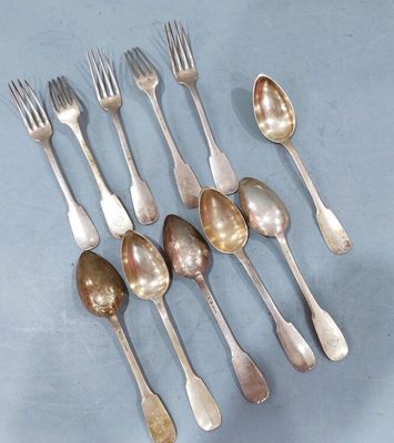 several spoons and forks are arranged in a row on a blue surface