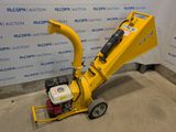 a small yellow machine sitting on top of a cement floor