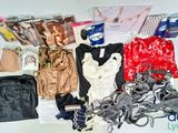 a lot of clothes and accessories laid out on a table