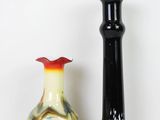 two vases sitting next to each other on a white surface
