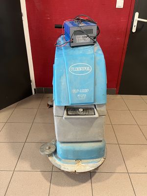 an image of a blue floor scruber in a room