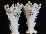 two white vases that are sitting next to each other