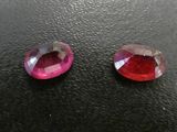 pair of pink tourmaline gems on black surface