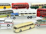 a lot of toy buses that are sitting on a table