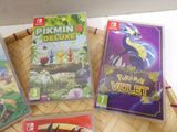 three nintendo wii games sitting on top of a basket on top of a table