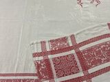 a red and white checkered table cloth with a monogram on it