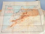 a map on the table with a lot of papers on it
