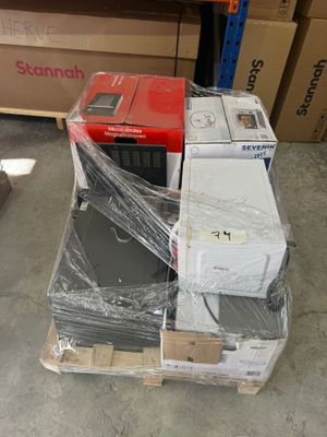 a stack of boxes and a microwave sitting on a pallet