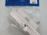 a white power adapter in a plastic bag on a table