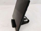a close up of a tablet computer on a stand on a white surface