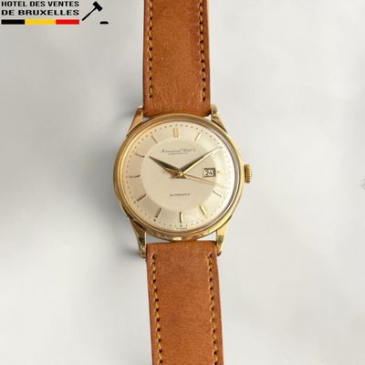 a watch that is sitting on a white surface