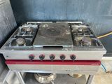 a gas stove that is sitting on a cart