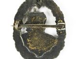 an old metal badge with a bird on top of it