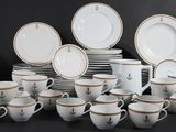 a lot of cups and saucers sitting on a table