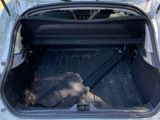 a trunk of a white car with the door open