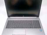 an open laptop computer sitting on top of a white table