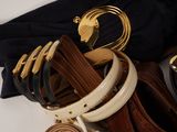 a lot of belts that are laying on a table