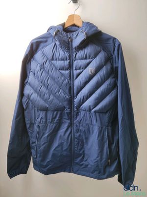 La veste est suspendue à un cintre dans un coin de la pièce.