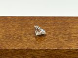 a small diamond sitting on top of a wooden box