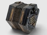 un petit accordéon noir posé sur une surface blanche