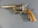 a gun that is on a table with a wooden handle
