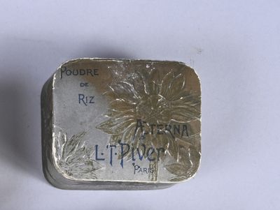 a small silver box with a flower on it