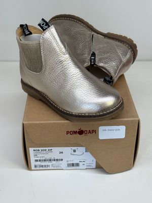 silver leather ankle boots with a gold sole and a brown sole