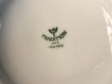 a white bowl with a green logo on it