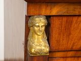 a statue of a woman sitting on top of a dresser