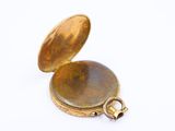 an image of a gold pocket watch on a white background