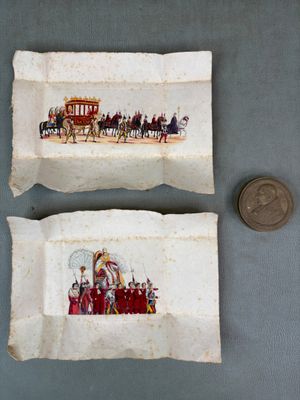 deux feuilles de papier sur lesquelles figurent l'image d'une calèche et une pièce de monnaie