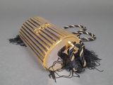 a gold purse with a tassel on a table