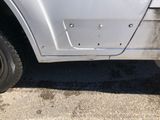 a close up of a car with a hole in the side of it