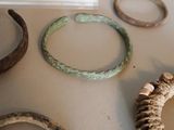 many different types of rings and bracelets on the table