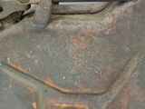 a rusted metal container sitting on the ground
