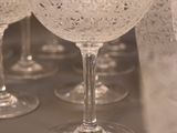 many wine glasses lined up on a table