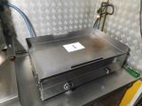 a large metal box sitting on top of a metal table