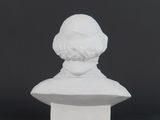 a white busturine of a man with a beard and a hat