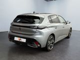 the rear end of a silver car parked in a garage